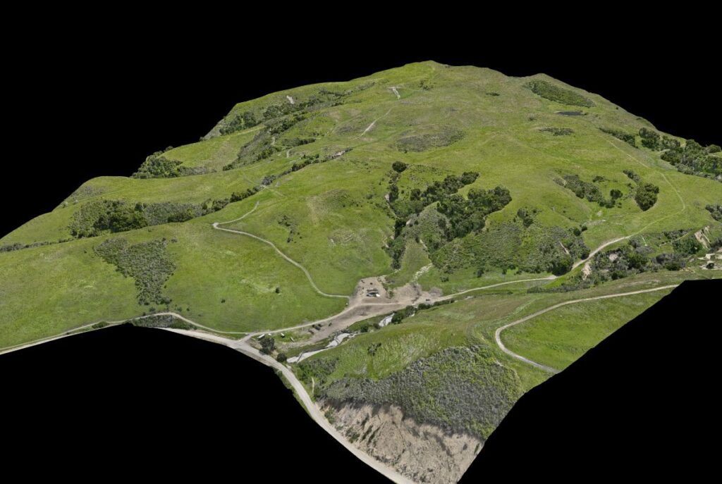 3d drone mapping of green hillside terrain with roads and construction area
